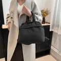 Quilted black puffer tote bag with drawstring detail and fluffy padded texture - Black