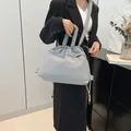Puffy quilted tote bag in light grey blue with drawstring closure and wide shoulder strap - Gray