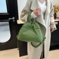 Quilted matcha green puffer tote bag with drawstring closure and padded shoulder strap - Green