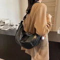 Modern black crescent hobo bag with contrast stitching and unique knotted shoulder strap - Black With Rabbit Pendant