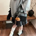 Black leather Boston bag with a brown puppy charm and a slim adjustable strap - 26*9*17cm / Black