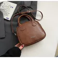 Detail of coffee brown PU leather bag with vintage patchwork stitching and top handles - Coffee