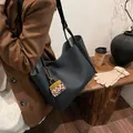 Large black leather tote bag with stylish leopard print charm and golden chain detail - With Leopard Pendant / Black