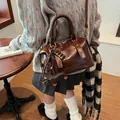 Dark brown glossy Boston handbag with chocolate and dachshund pendants and shoulder strap - With Pendant / Brown