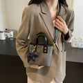 Retro mini bucket bag in dark grey textured finish with a cute black dog charm accessory - 19*9*16 / Off White