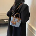 Chic blue denim bucket bag with brown leather trim and cute puppy charm detail - 19*9*16 / Blue