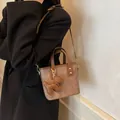Vintage brown leather bucket bag with dog charm on a black coat wearing model - 19*9*16 / Coffee