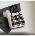 Detail of soft white fleece tote bag with black and white plaid pocket and leather handles - Off White