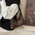 Minimalist large crescent shoulder bag in dark brown PU leather with braided charm - Brown