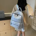 Quilted padded backpack in light blue puffer material shown on model for daily casual wear - 30*13*40 / Blue