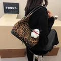 Leopard print tote bag with black leather trim and cute white puppy keychain charm - Brown