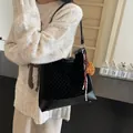 Black suede crossbody bucket bag with bear pendant and polka dot rivet accents - Black