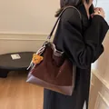 Brown suede tote bag with white polka dots and bear charm accessory in casual style - Brown
