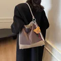 Brown suede polka dot shoulder bag with leather trim and cute bear keychain accessory - Elephant Gray