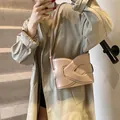 Chic beige crescent underarm bag with layered flap design and adjustable crossbody strap - Khaki