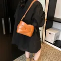 Brown moon crescent crossbody bag with woven textured faux leather and adjustable strap - Brown