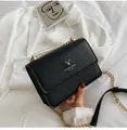 Detail of black leather texture and golden deer logo on fashion chain crossbody bag - Black