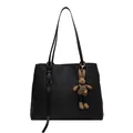 Large black minimalist tote bag with chic rabbit charm and tassel detail on white background - Black With Rabbit Pendant