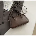 Deep brown matte leather Boston bowling bag with top handles and adjustable strap - No Pendant / Brown
