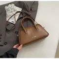 Minimalist dark brown bowling bag in vintage leather with top handles and strap - No Pendant / Brown