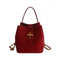 Chic red bucket bag with matte leather texture and elegant golden cross lock - Red