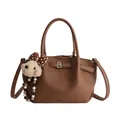Dark brown leather bucket bag with silver twist lock and cute dog keychain accessory - With Pendant / Brown