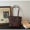 Deep brown two-tone tote bag with MIKAXIQI branding and gold rivet detailing - Coffee