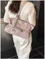 Detail of vintage tote bag shoulder strap with metallic eyelets and buckle on model - Gray