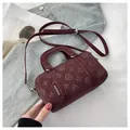 Chic burgundy cylindrical baguette bag with floral embossing and slim shoulder strap - No Pendant / Burgundy