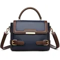 Bolso de mano de cuero azul oscuro y marrón con detalles dorados y correa ajustable - Azul