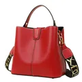Red lychee grain leather bucket handbag with contrast stitching and wide shoulder strap - Red