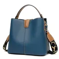 Dark blue leather bucket bag with brown handles and a patterned wide strap - Blue