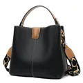 Black pebbled leather bucket bag with brown accents and wide jacquard strap - Black