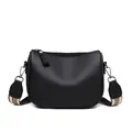 Black pebbled PU leather saddle bag with a striped woven wide shoulder strap on white base - Black