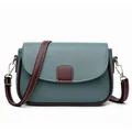 Peacock blue leather saddle bag with contrast brown trim and gold hardware details - Blue