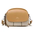 Elegant two-tone mini round crossbody bag in cream and tan leather with silver hardware - Apricot