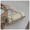 Chic beige cylindrical bucket bag with pleated texture and gold metal ring accents - Standard Type / Off White