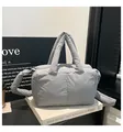 Light grey quilted puffer tote bag with padded top handle and wide shoulder strap - Gray