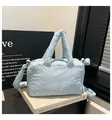 Light blue quilted puffer tote bag with padded handles and adjustable shoulder strap - Blue