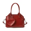 Borsa a conchiglia rosso scuro lucida in pelle cerata con ciondolo a cuore coordinato - Rosso