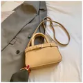 Beige lychee texture crossbody bag with silver hardware on a soft fabric backdrop - Khaki (No Pendant)