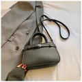 Minimalist black lychee texture leather handbag with adjustable shoulder strap and metal buckle - Black without Pendant