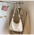 White faux leather hobo shoulder bag featuring a unique knot detail on the strap - White