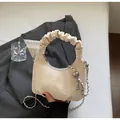 Beige ruched dumpling bag with cartoon embroidery and decorative silver metal chain - Off White