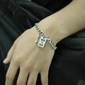 Men's silver Cuban chain bracelet featuring dumbbell charm and ME vs ME engraved square tag - Diamond Shape ME Style