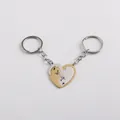 Detail of magnetic heart-shaped cat keychain set in silver and gold tone metal finish - Heart Cat / Gold White