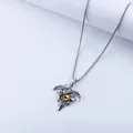 Close-up of gothic eagle wing pendant featuring a sharp silver metal finish and yellow eye - Yellow Citrine-look Pendant