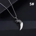 Detailed macro view of a vintage silver tiger head pendant with a curved white tooth charm - Antique Silver Tiger Head White Fangs (5#)