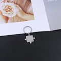 Minimalist stainless steel puzzle piece keychain for couples on a stylish lifestyle background - Convex Puzzle