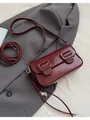 Minimalist wine red baguette bag in glossy leather with silver buckles and heart charm - Red with Pendant